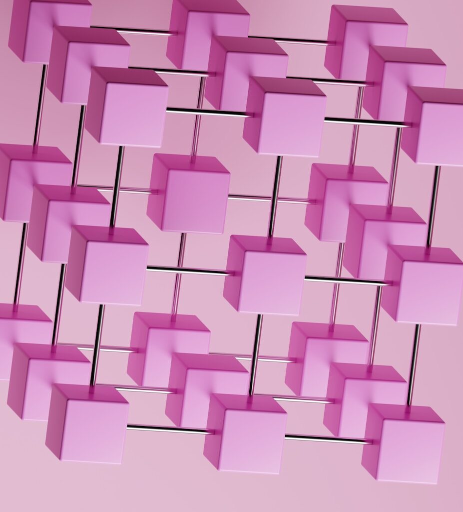 a bunch of pink cubes hanging from a pink wall