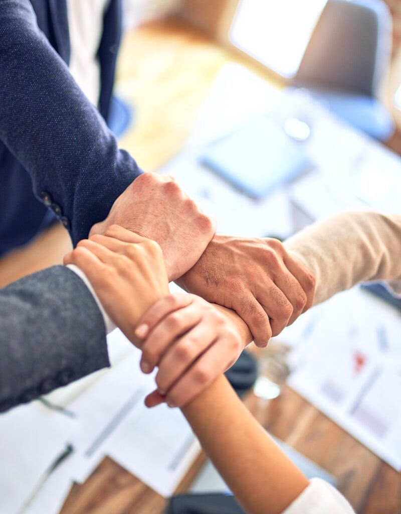 person in black long sleeve shirt holding persons hand