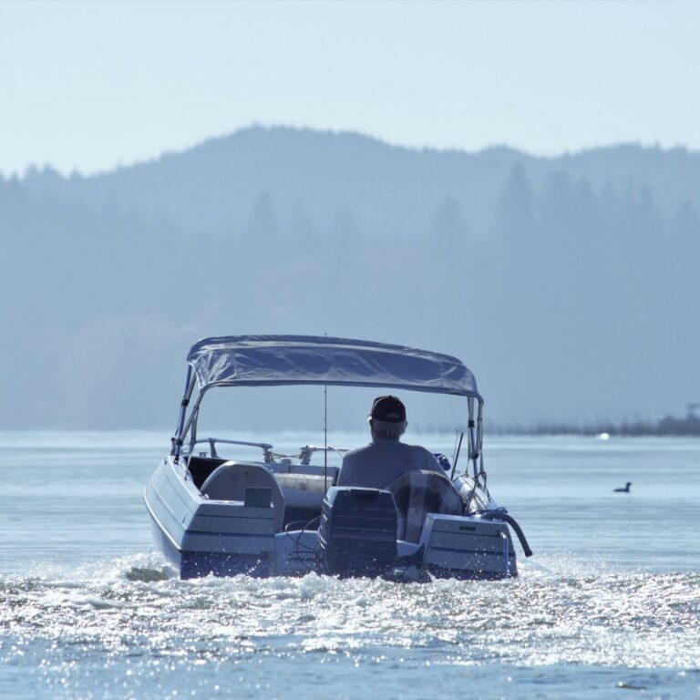 a man driving a boat in the water